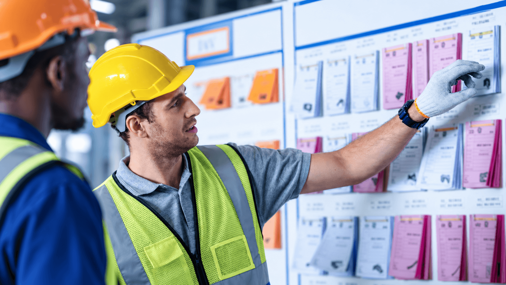 Manufacturing employee taking part in a short team performance briefing on the shop floor.